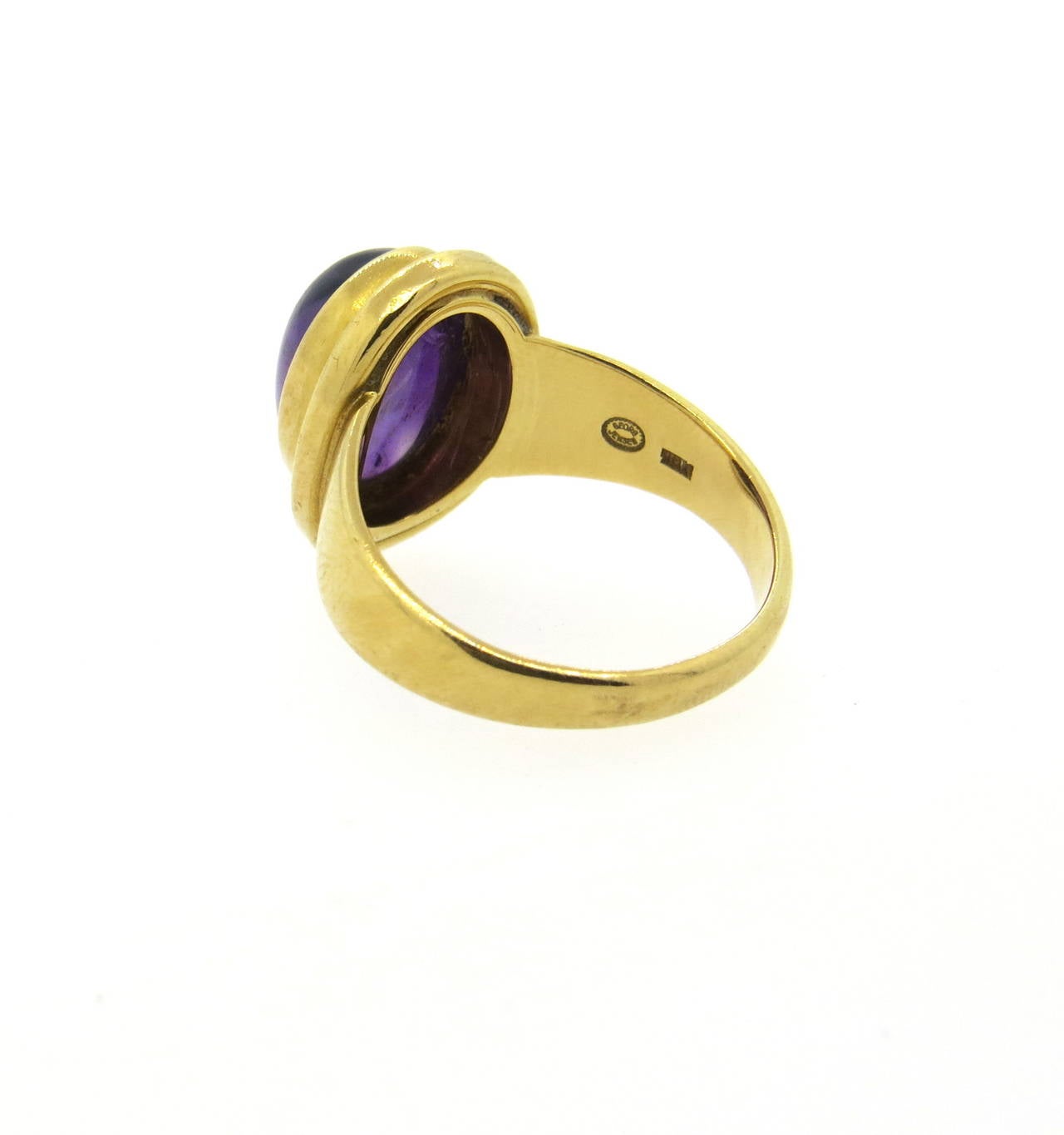 An 18k yellow gold ring set with an amethyst cabochon weighing approximately 5 carats.  Crafted by Georg Jensen, the ring is a size 7.5 and weighs 8.3 grams. Marked Georg Jensen 1048 B 750