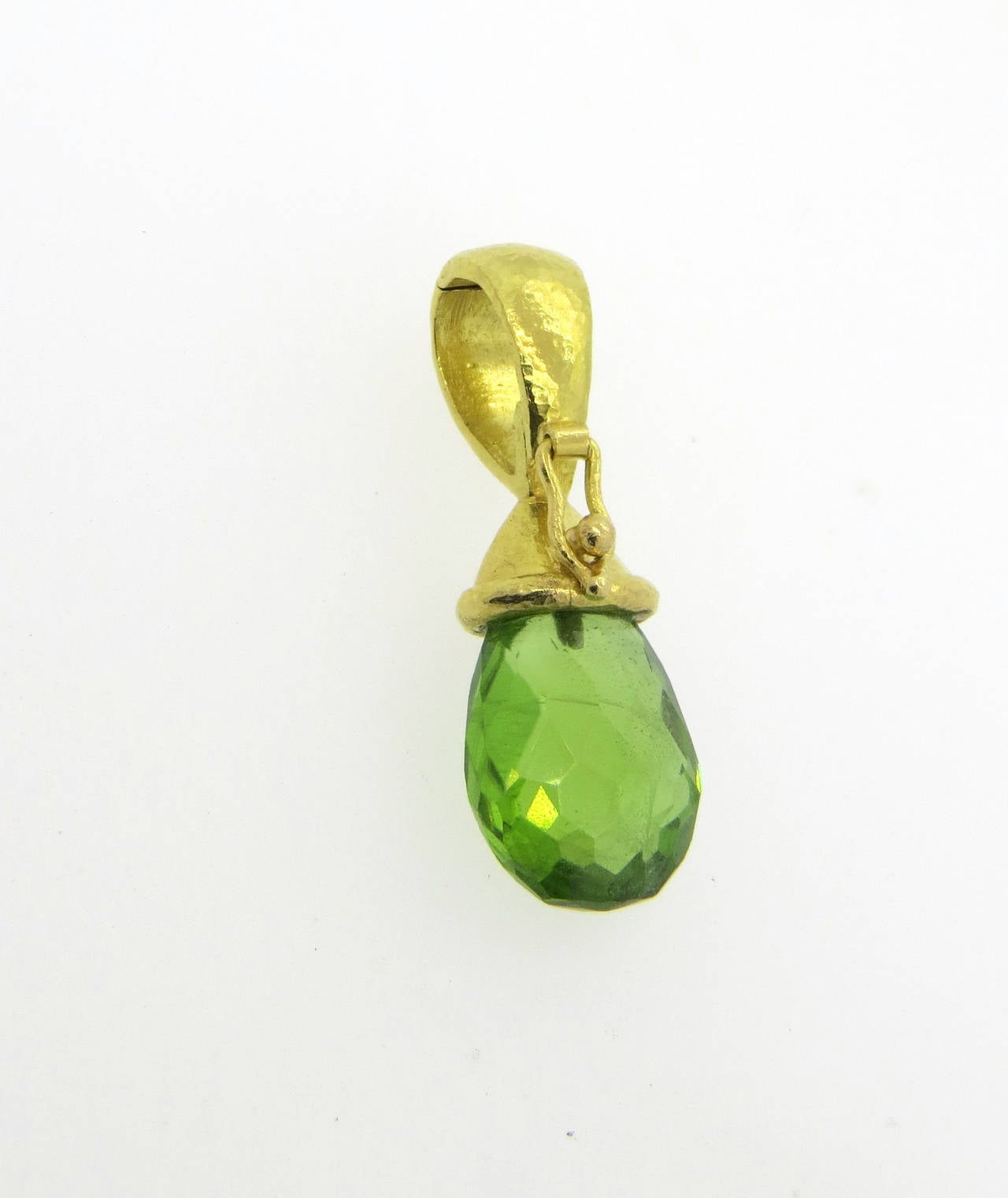 An 18k yellow gold pendant set with a faceted peridot.  Crafted by Elizabeth Locke, the pendant measures 31mm x 11mm and weighs 5.7 grams.