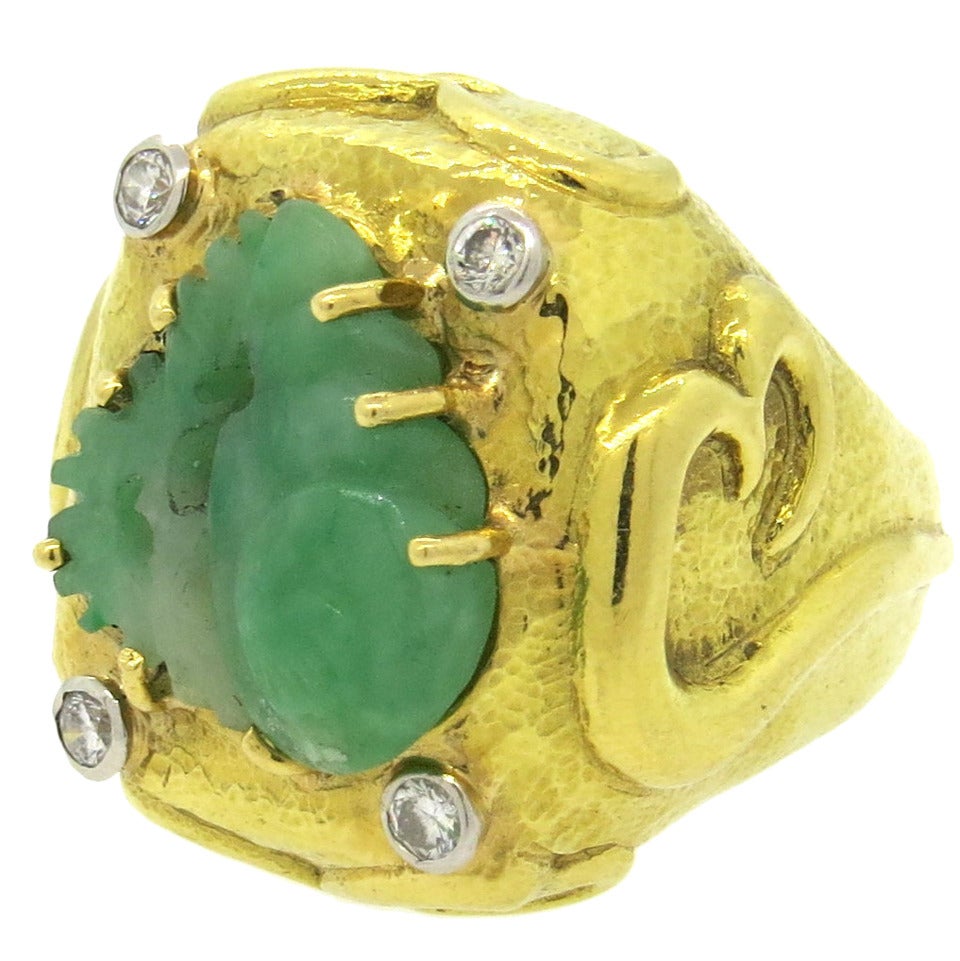 An 18k yellow gold and platinum ring set with a carved jade and approximately 0.24ctw of G/VS diamonds.  Crafted by David Webb, the top of the ring measures 23mm x 25mm and sits 13.5,mm from the finger.  The ring is a size 6 and weighs 24.6 grams.