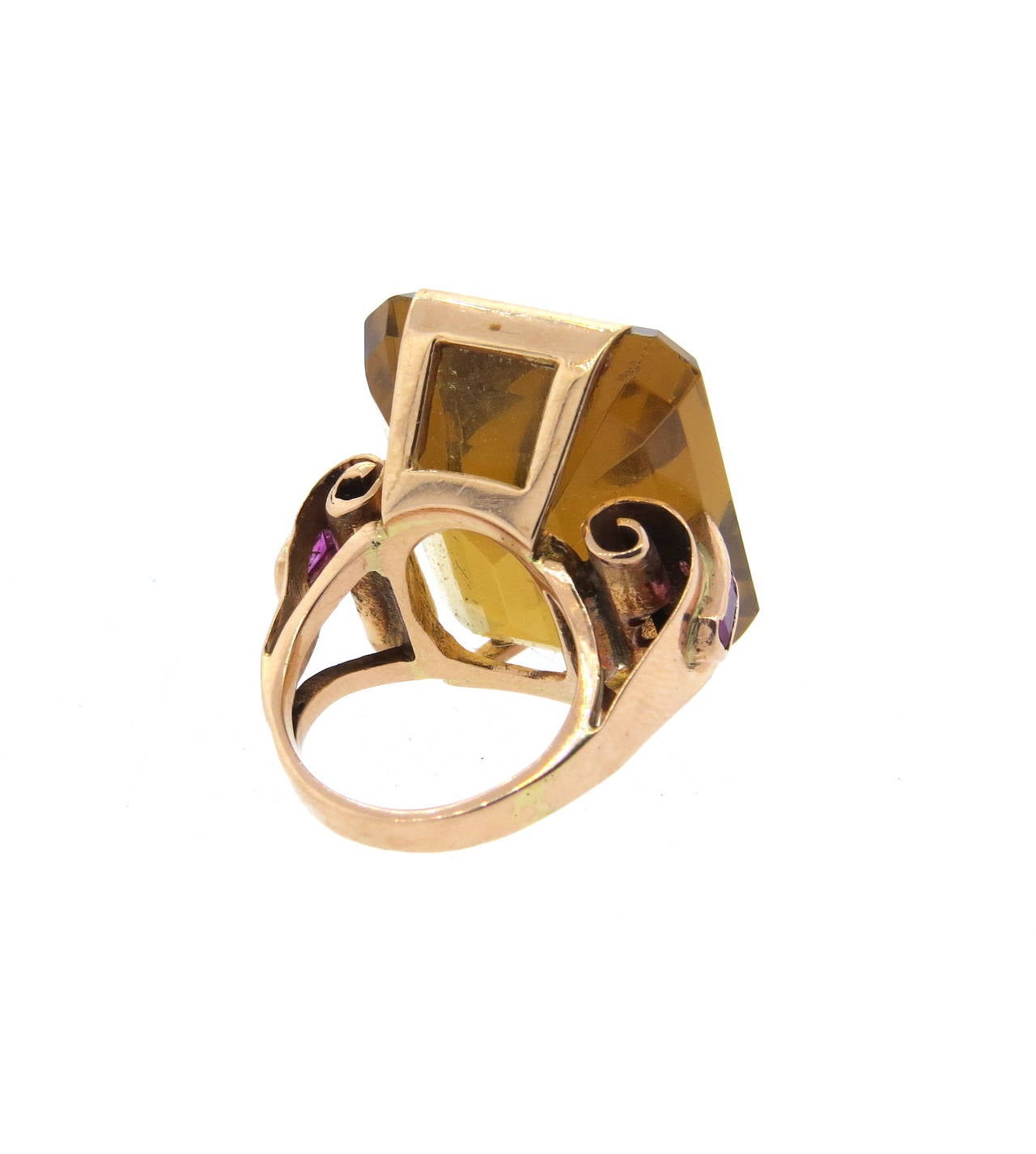 Retro circa 1940s 14k rose gold ring, set with an approx. 39.5-40ct citrine, surrounded with four side rubies. Ring is a size 4 1/4, top of the ring - 25mm x 25mm, sits approx. 12mm from the finger. Weight of the piece - 17.7 grams
