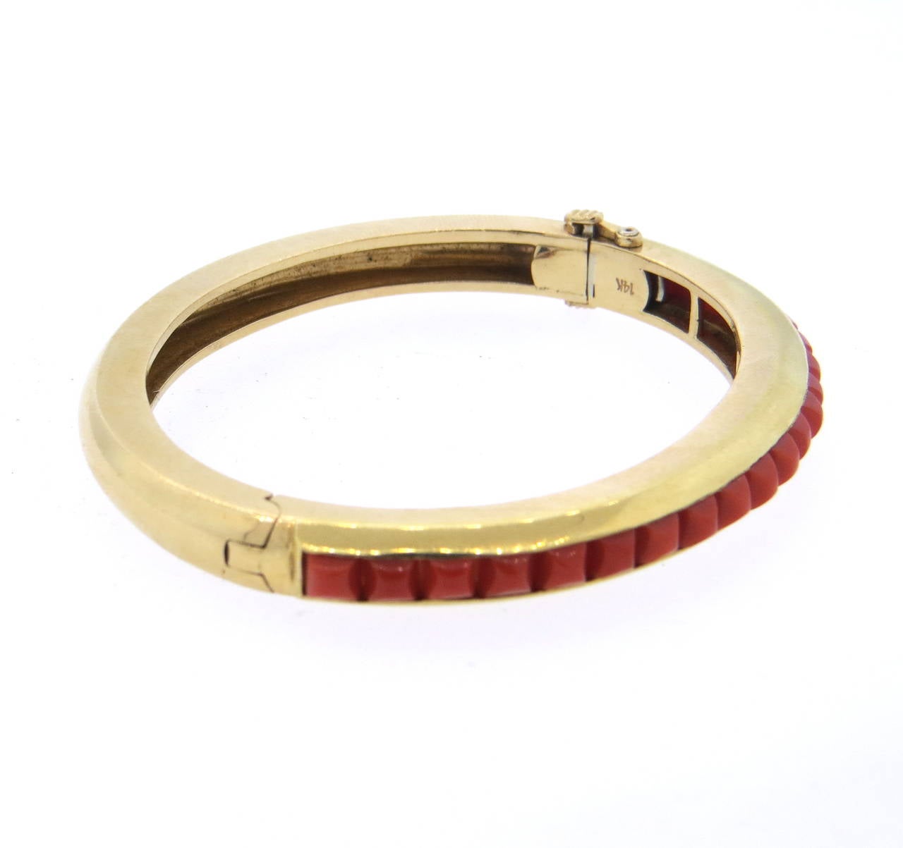 Mid Century 14k gold bangle bracelet, set with suragloaf cut coral stones. Bracelet will fit up to 7