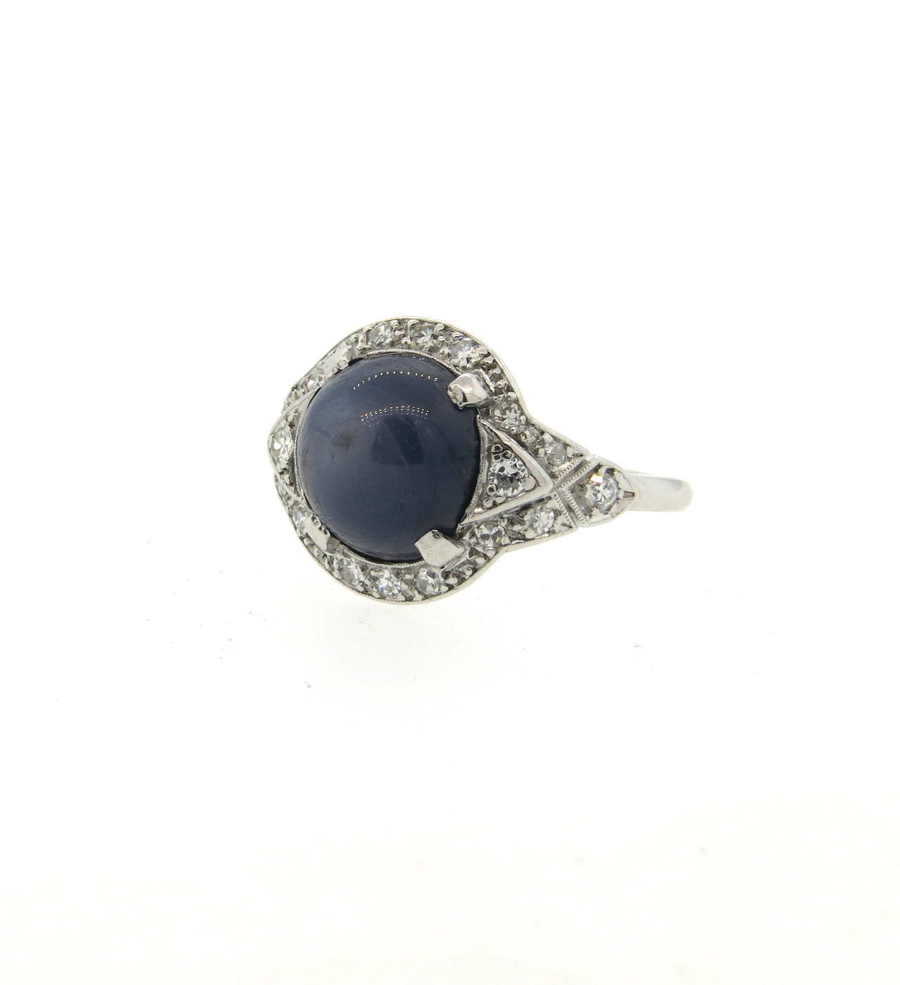 Antique platinum ring, set with a 10.1mm star sapphire cabochon, surrounded with diamonds. Ring is a size 6 1/4, top measures 14mm in diameter. Weight of the piece - 6.8 grams