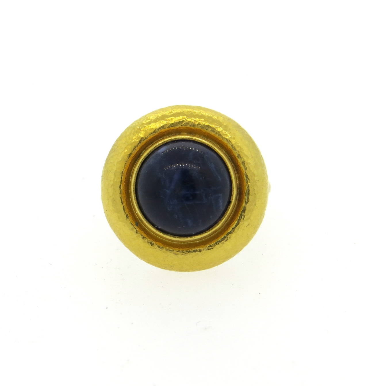 18k gold ring, crafted by Ilias Lalaounis, set with a 12.3mm blue stone in the center. Ring is a size 6 1/2, ring top is 21mm in diameter. Marked 750,Lalaounis mark. Weight -11 grams