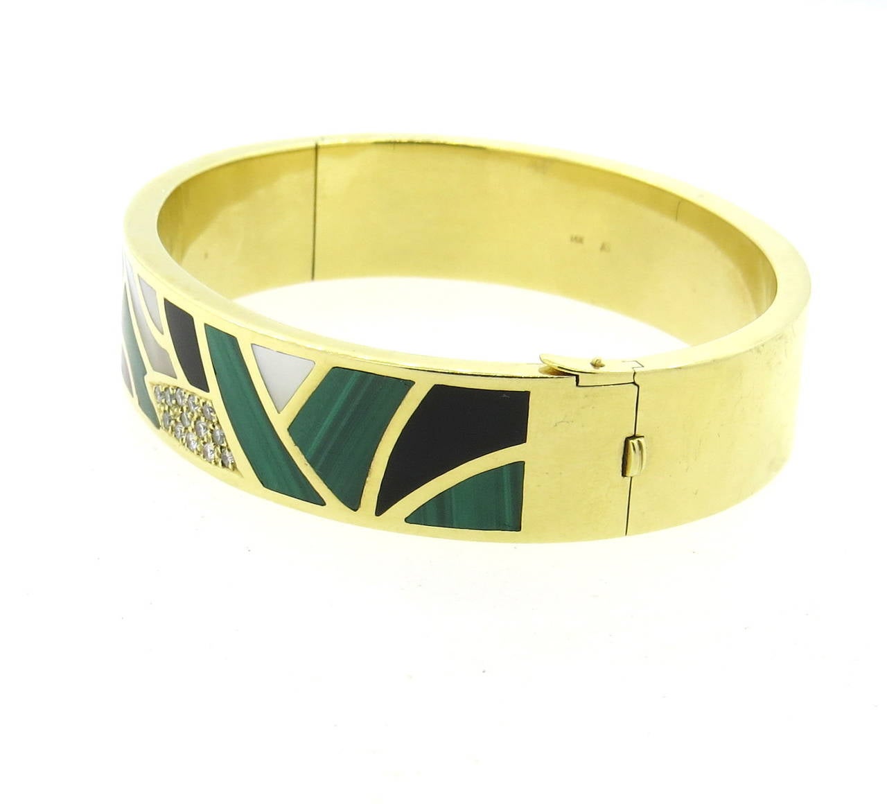 A 14k yellow gold bracelet adorned with mother of pearl, onyx, malachite, purple suglite and approximately 0.13ctw of G/VS diamonds.  Crafted by Asch Grossbardt, the bracelet comfortably fits up to a 7.25