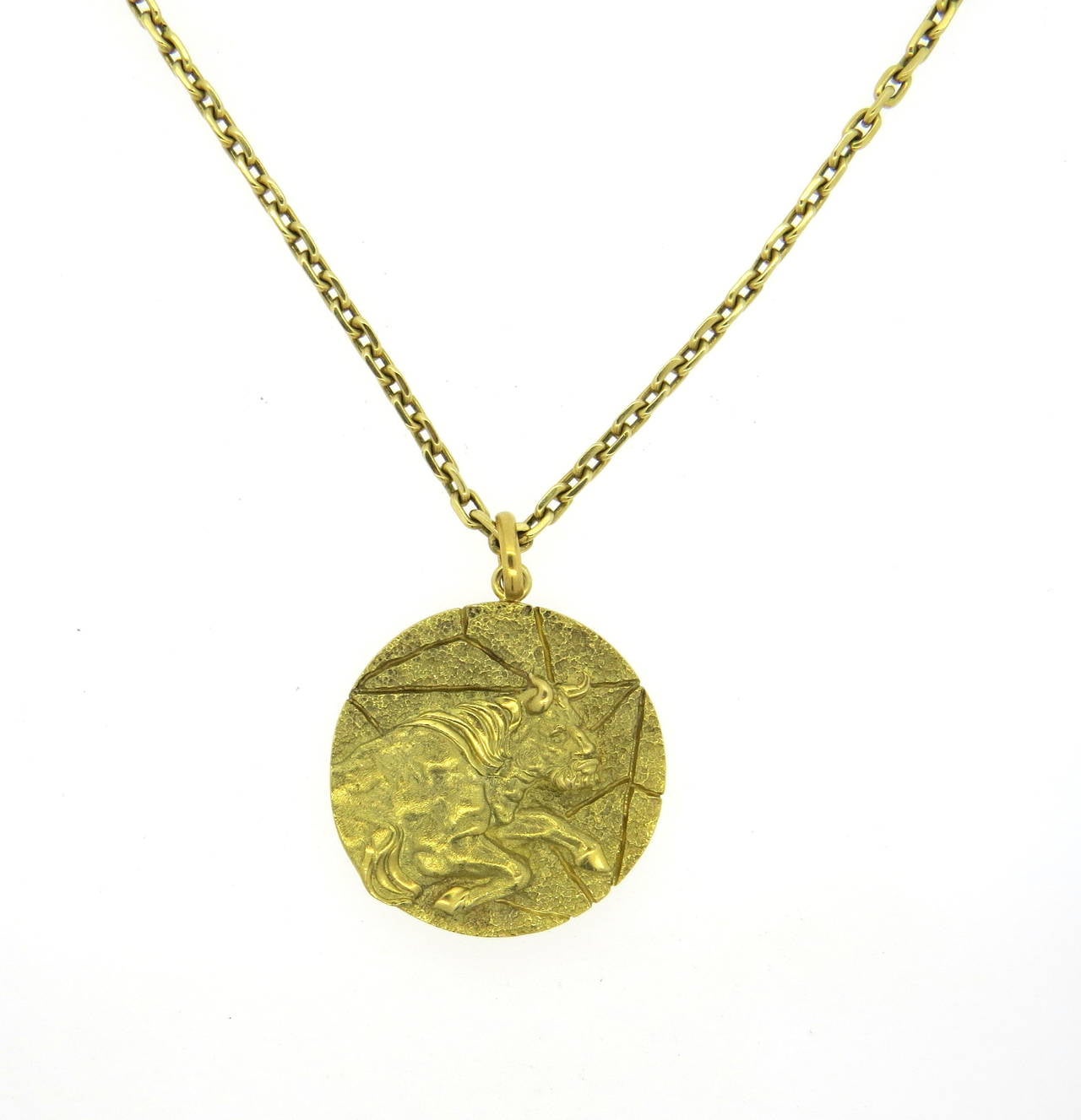 An 18k yellow gold necklace depicting a Taurus Zodiac symbol.  Crafted by Tiffany & Co, the necklace measures 25.5