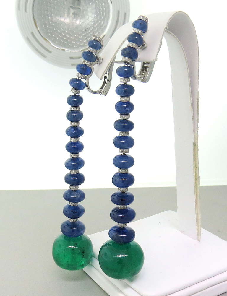 18k white gold earrings by de Grisogono with 73.71ctw blue sapphires,66.85ctw in emerald cabochons and 1.12ctw diamonds. Earrings are 95mm long. Come with copy of the de Grisogono certificate of authenticity,with total value of $221,300.00 
weight