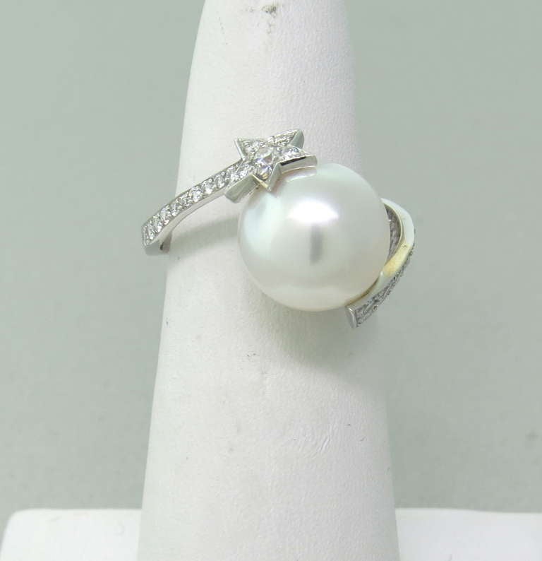 Modern 18k white gold ring by Chanel from Cometes collection, featuring 11mm pearl ,surrounded by diamonds. Ring size 7 1/2. Marked Chanel,750,601296. 52. weight 4.8g