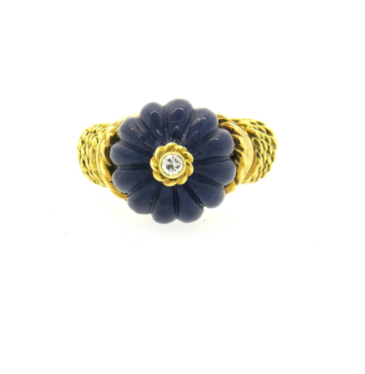 An 18k yellow gold ring set with a carved lapis 14.8mm in diameter and a G/VS diamond weighing approximately 0.08ct.  The ring is a size 7, sits 16mm from the finger.  Marked 18k