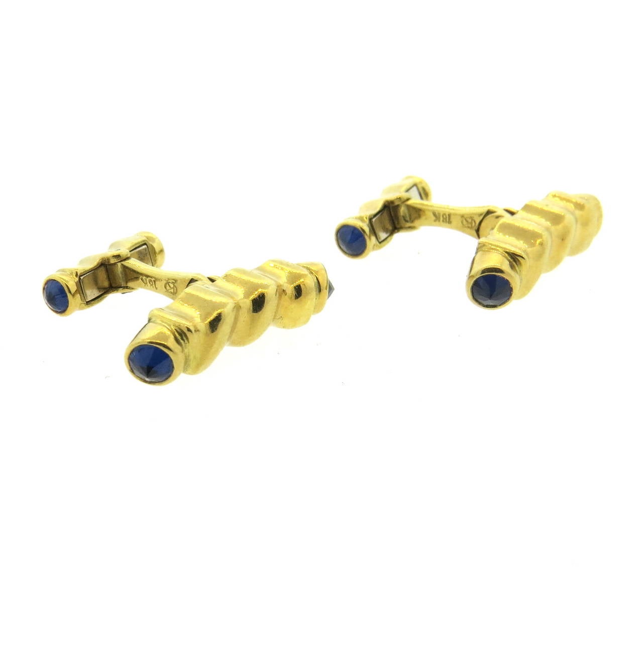 Large 18k yellow gold twist cufflinks, set with blue sapphires. Top measures 27mm x 6mm. Marked 18k. Weight - 25.2 grams