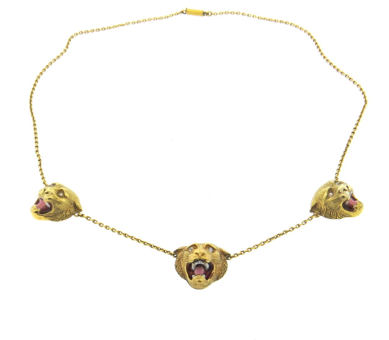 Beautiful antique 18k gold necklace, featuring three lion head stations, each decorate with Old Mine cut diamond eyes, and a combination of red, pink and white enamel mouths. Necklace is 18 1/4