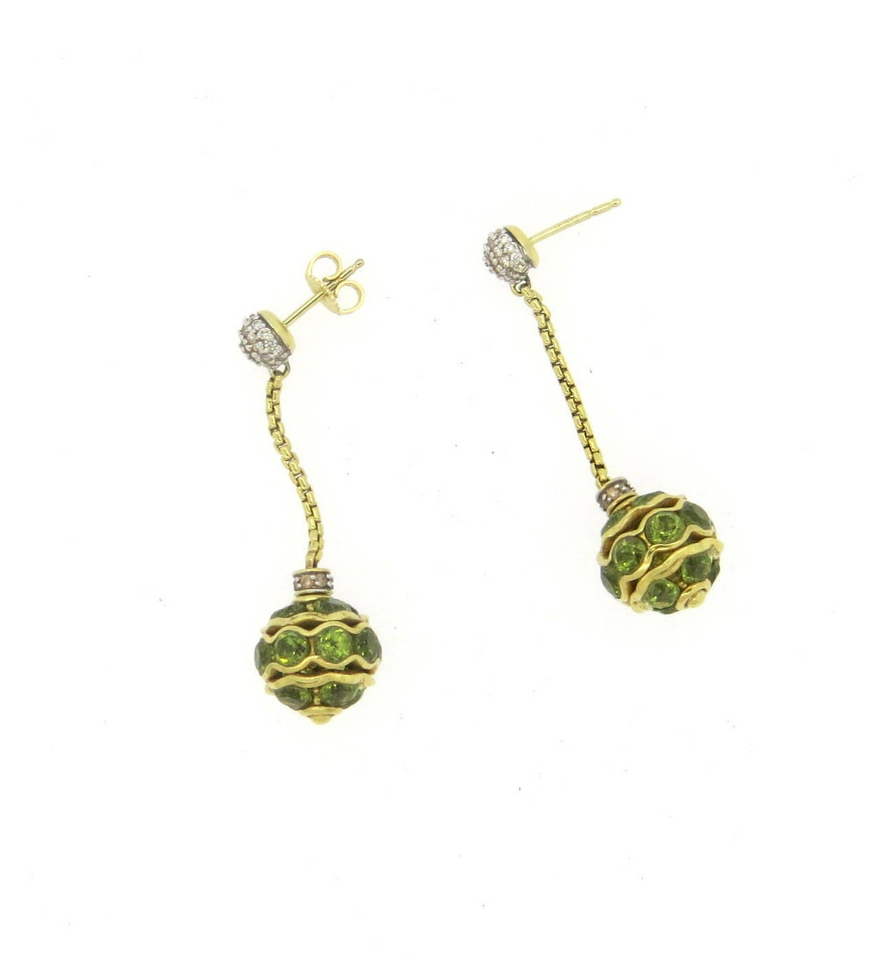 18k gold long earrings, crafted by David Yurman, featuring peridot ball drop, decorated with diamonds. Earrings are 45mm long and 12mm wide - one earring back is missing. Marked D.Y.,750. Weight - 15.9 grams