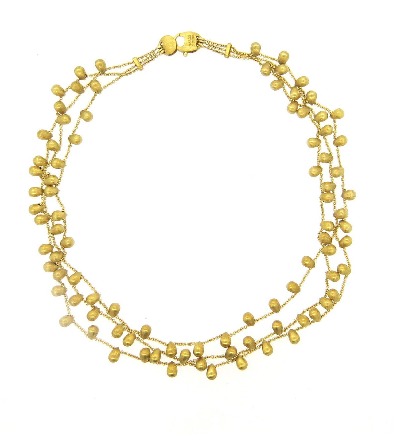 18k yellow gold three strand necklace, crafted by Marco Bicego for Acapulco collection. Necklace is 16