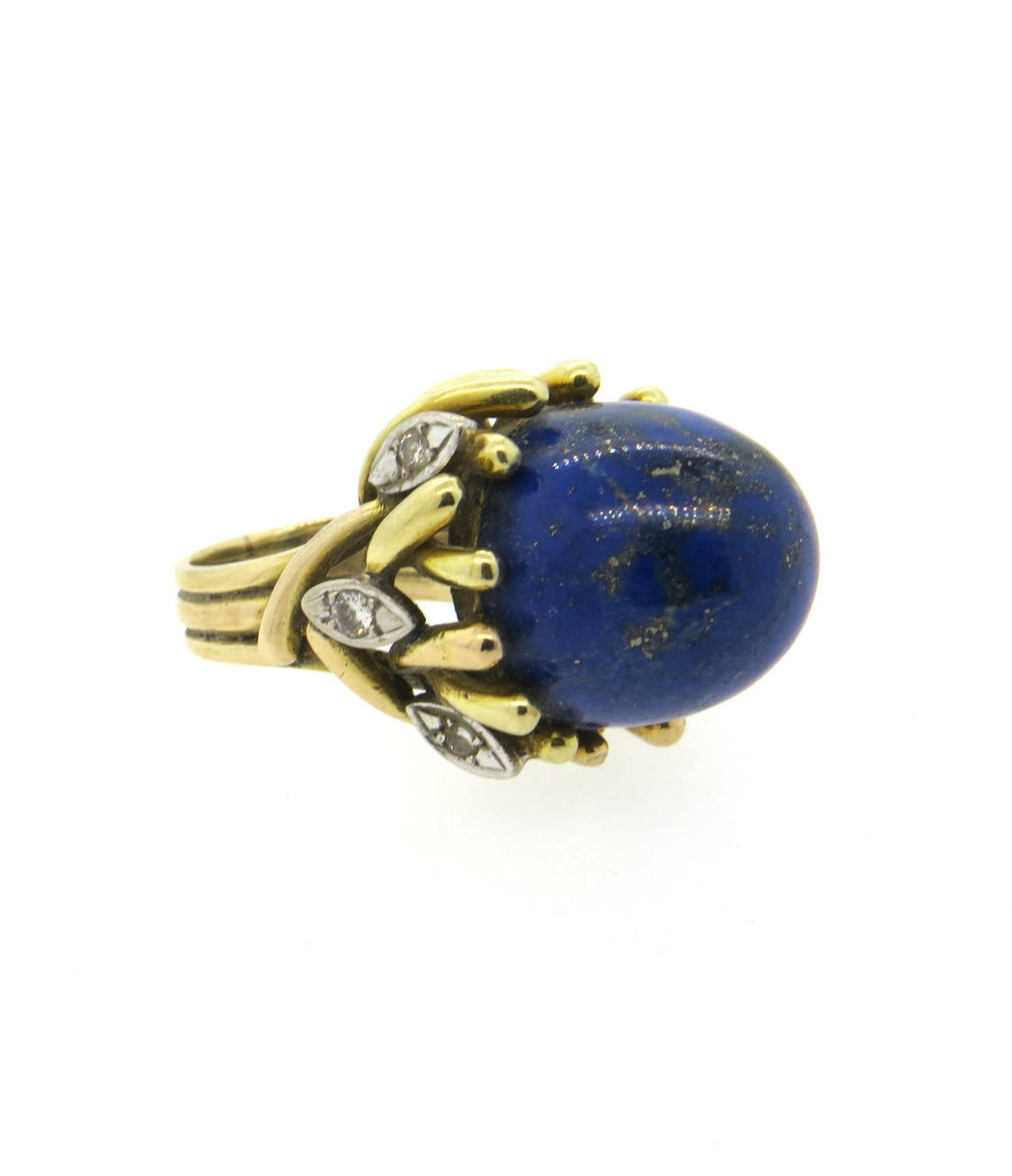 Impressive 18K gold cocktail ring circa 1960s featuring lapis and decorated with diamonds. Ring size 5.5, top measures 24mm in diameter. Ring sits approximately 22.5m from finger. Weight - 22.8 grams.