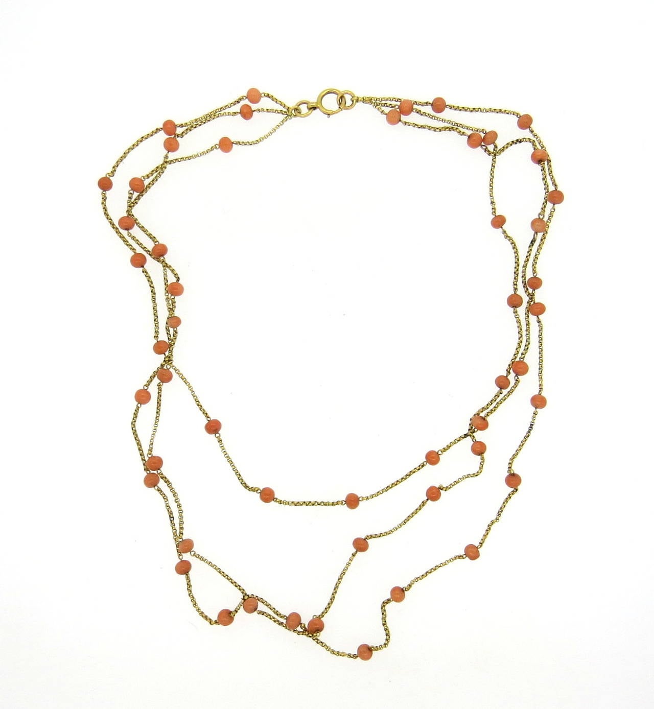 Lovely 14K gold three strand coral bead necklace. Coral beads measure approximately 4.5mm in diameter. Necklace's shortest strand measures 16