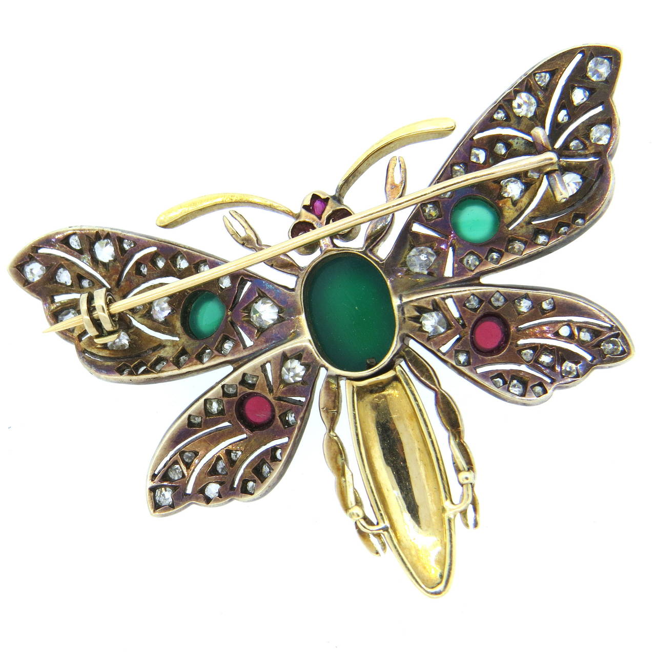 An 18k gold and silver butterfly brooch set with chrysoprase and tourmaline cabochons.  The wings are adorned with old cut and rose cut diamonds.  The brooch measures 62mm x 46mm and weighs 20.9 grams.