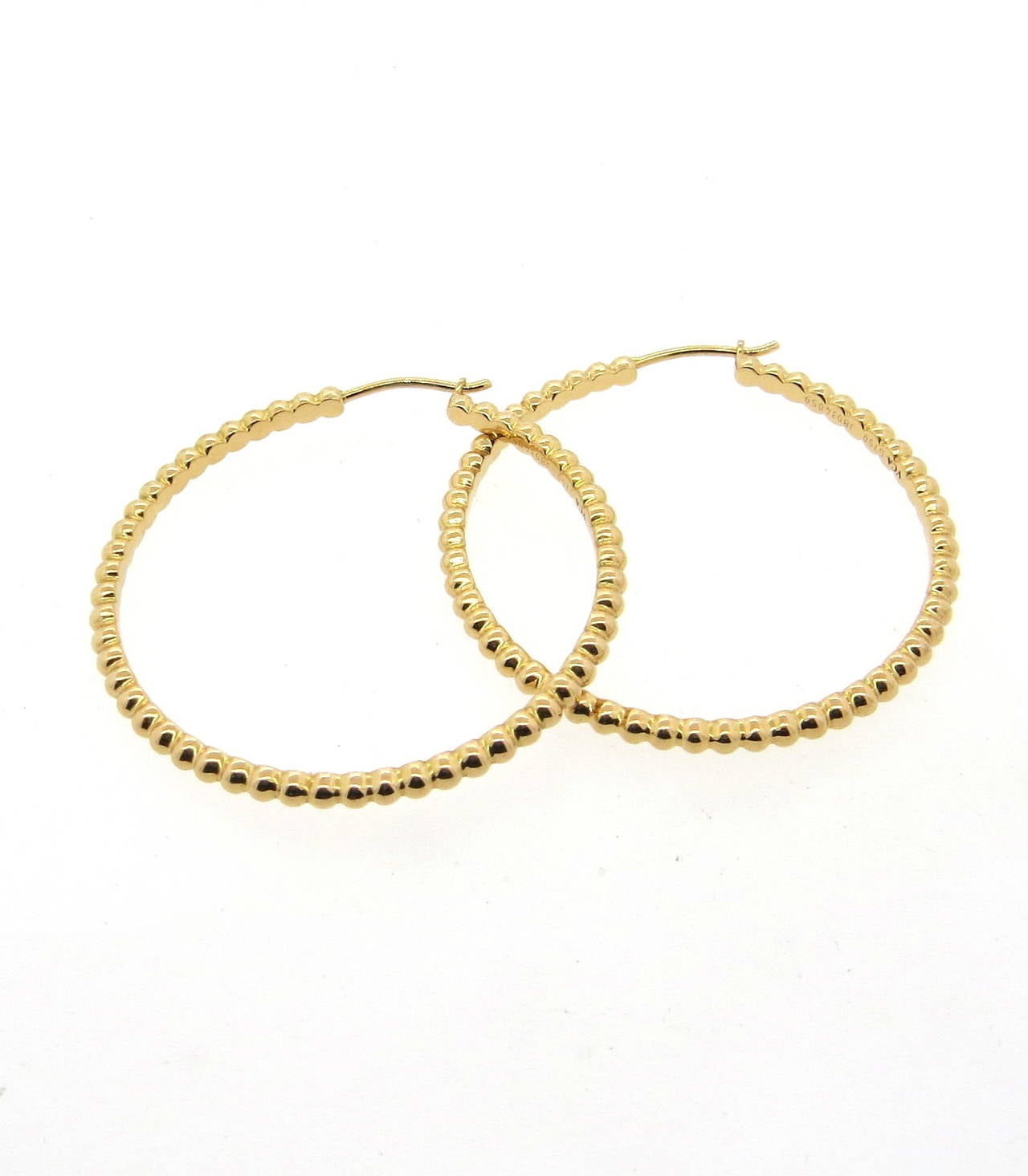 Remarkable 18K gold beaded hoop earrings from Van Cleef & Arpels from the Perlee collection. Earrings measure 40mm in diameter, 2.7mm wide. Earrings are marked VCA, G750, JB034059. Weigh 15.2 grams. Earrings retail for $2,800.
