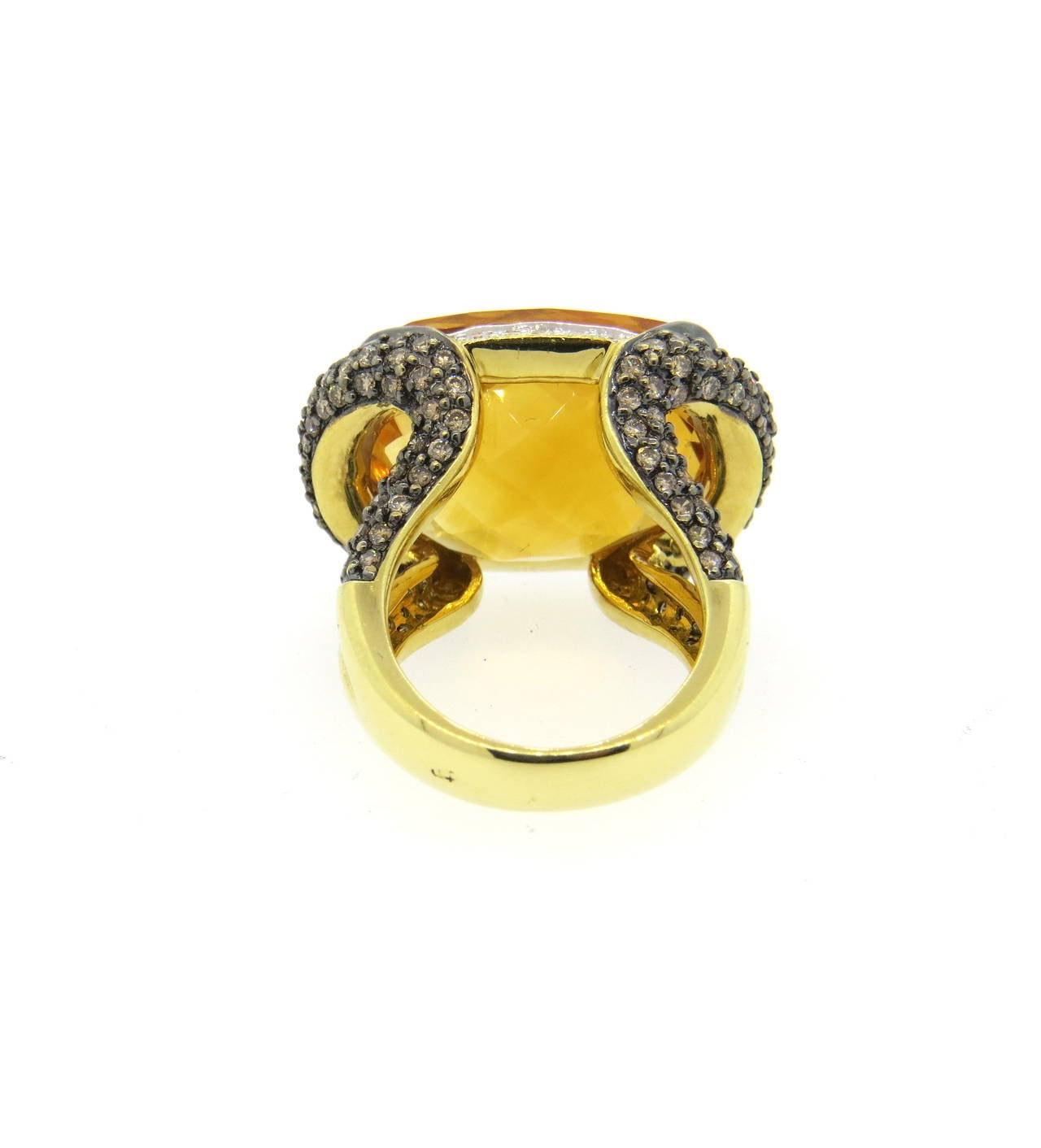 Beautiful 18K gold cocktail ring featuring a faceted citrine center decorated with approximately 1.80ctw of fancy diamonds and 0.15ctw of white diamonds. Ring size 5.25, ring top measures 25mm x 17.8mm. Marked 750 18K, weighs 17.7 grams.