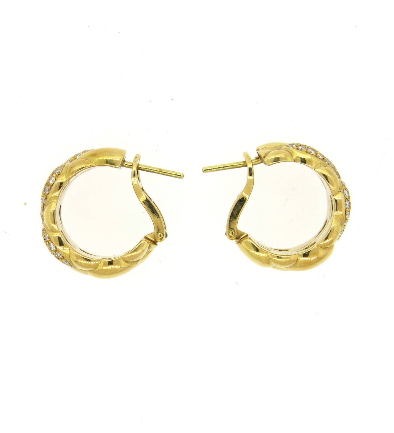 Exquisite 18K gold Chopard hoop earrings from the Casmir collection. Earrings feature approximately 1.25ctw of brilliant diamonds. Hoops measure 22mm in diameter, 11.4mm wide. Marked Chopard, Casmir, 750. Earrings weigh 23.1 grams.