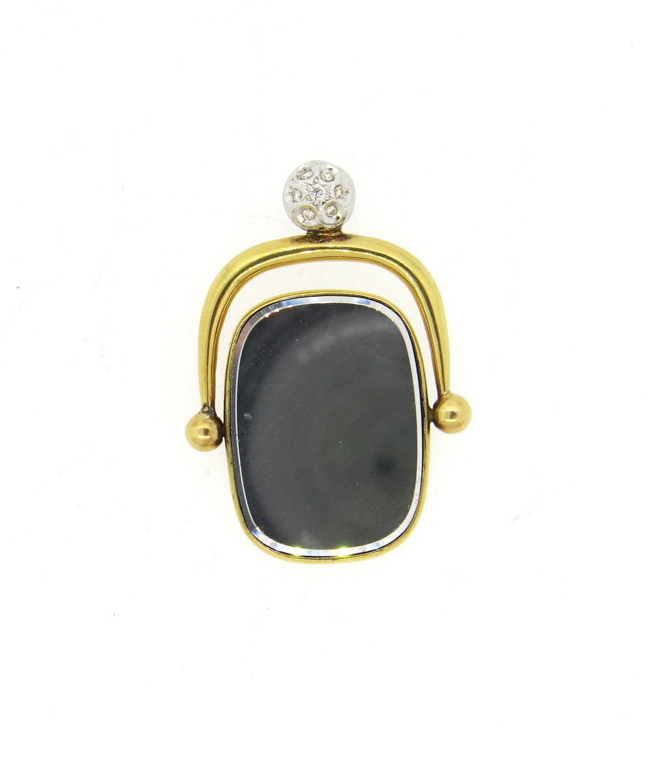 Unusual and artistic 18k gold pendant fob, decorated with diamonds on bale, featuring mirror on one f the flipping sides. Pendant measures 39mm x 30mm. Weight of the piece - 11.3 grams