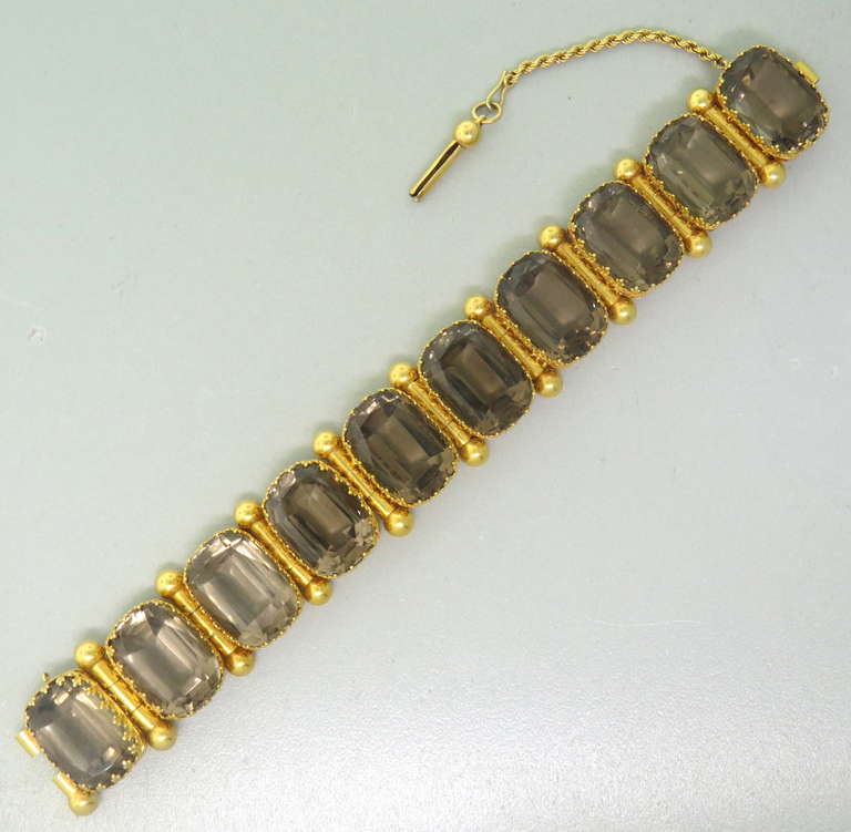This stunning piece of antique jewelry is made of 14k Yellow gold and 150 ctw of smokey topaz.  It is in pristine condition.  The bracelet is 7