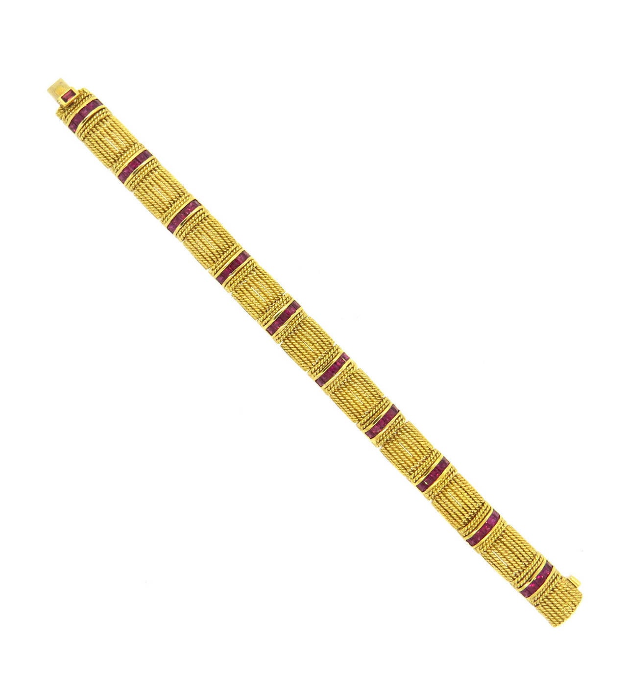 18k yellow gold multi-row bracelet, crafted by Roberto Coin, set with vibrant rubies. Bracelet is 7