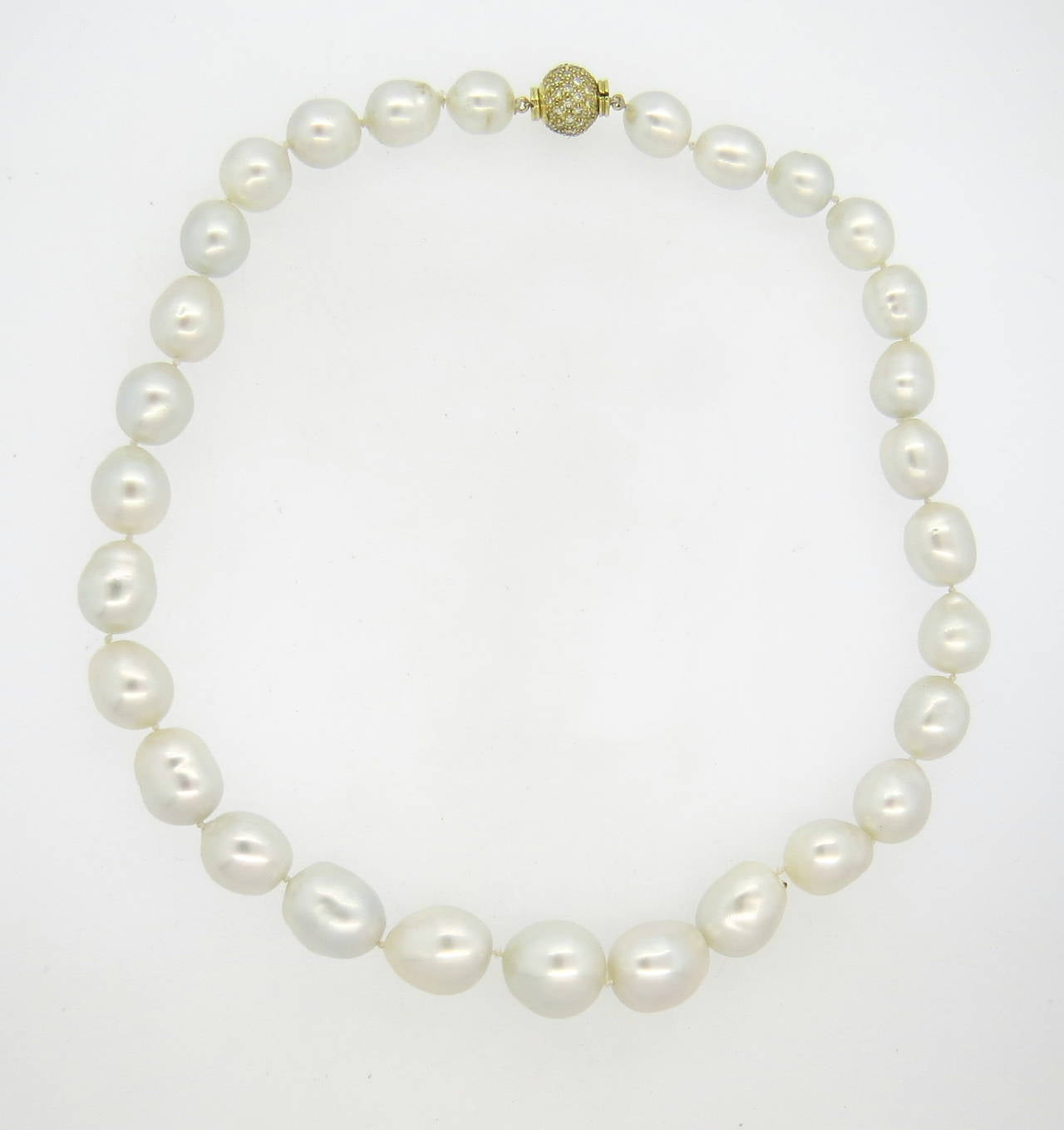 A necklace featuring graduated south sea baroque pearls ranging from 12.5mm x 10.8mm to 17.7mm x 18mm and an 18k gold clasp set with approximately 0.70ctw of G/VS diamonds.  The necklace is 19.5