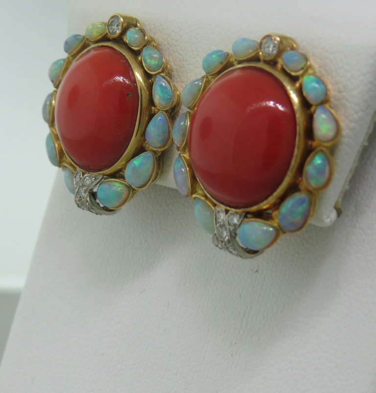 Circa 1960s, 18k gold earrings with 14.4mm red corals,surrounded by diamonds and opal gemstones. Earrings are 24mm x 22mm. Weight - 19g.