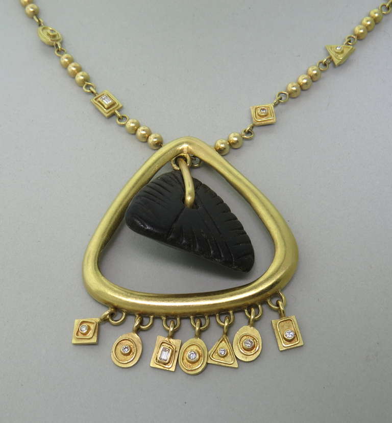 Artisan crafted necklace in at least 18k gold, with diamonds and stone. Necklace is 22