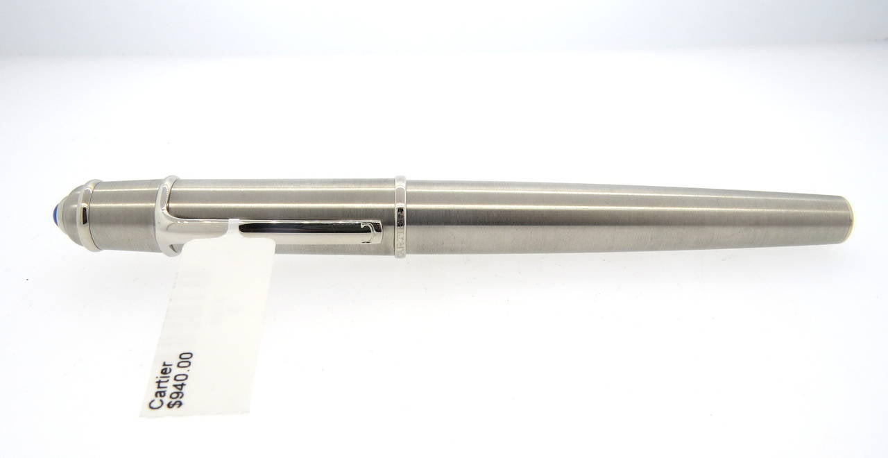 Cartier Diabolo stainless steel and platinum finish fountain pen. Pen measures 145mm and features a jeweler's sapphire on the cap. Pen is a brand new store sample. Comes with box, booklets and 2 cartridges. Pen is marked Cartier, 109819. Reference