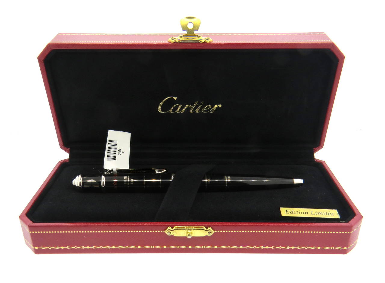 Limited Edition Cartier palladium finished black lacquer ballpoint pen featuring a cinema clap design. Pen also features ruby on end. Pen measures 140mm long. Brand new store sample, comes with original box and booklet. Pen is marked 0250/2008,