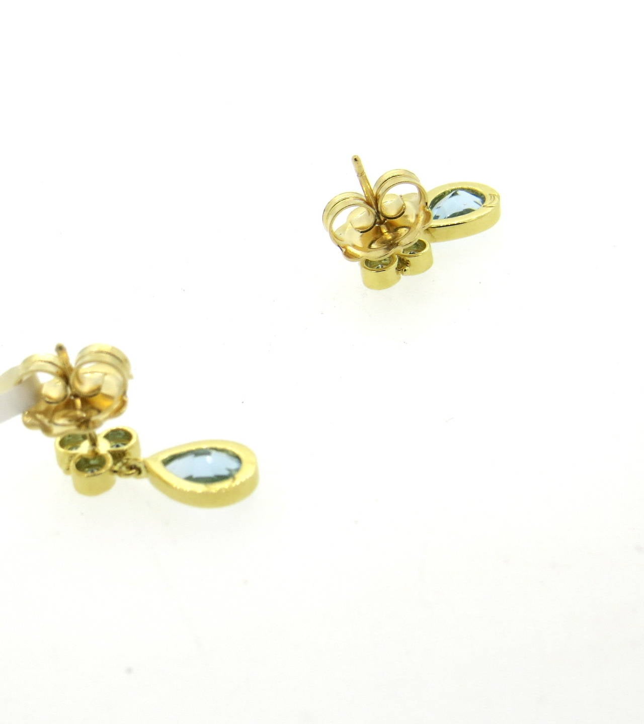 A pair of 18k yellow gold earrings set with aquamarines.  Crafted by Temple St. Clair, the earrings measure 19mm x 7mm and weigh 4.8 grams.  The earrings retail for $2500.
