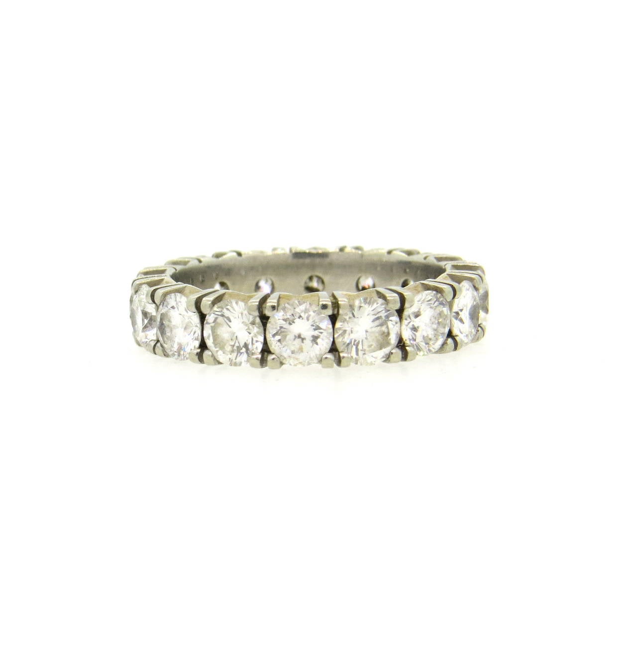An 18k white gold eternity wedding band ring set with 16 H/VS-SI diamonds approximately 4ctw.  The ring is a size 7.25 and 4.2mm in width.  The weight of the band is 4.9 grams.