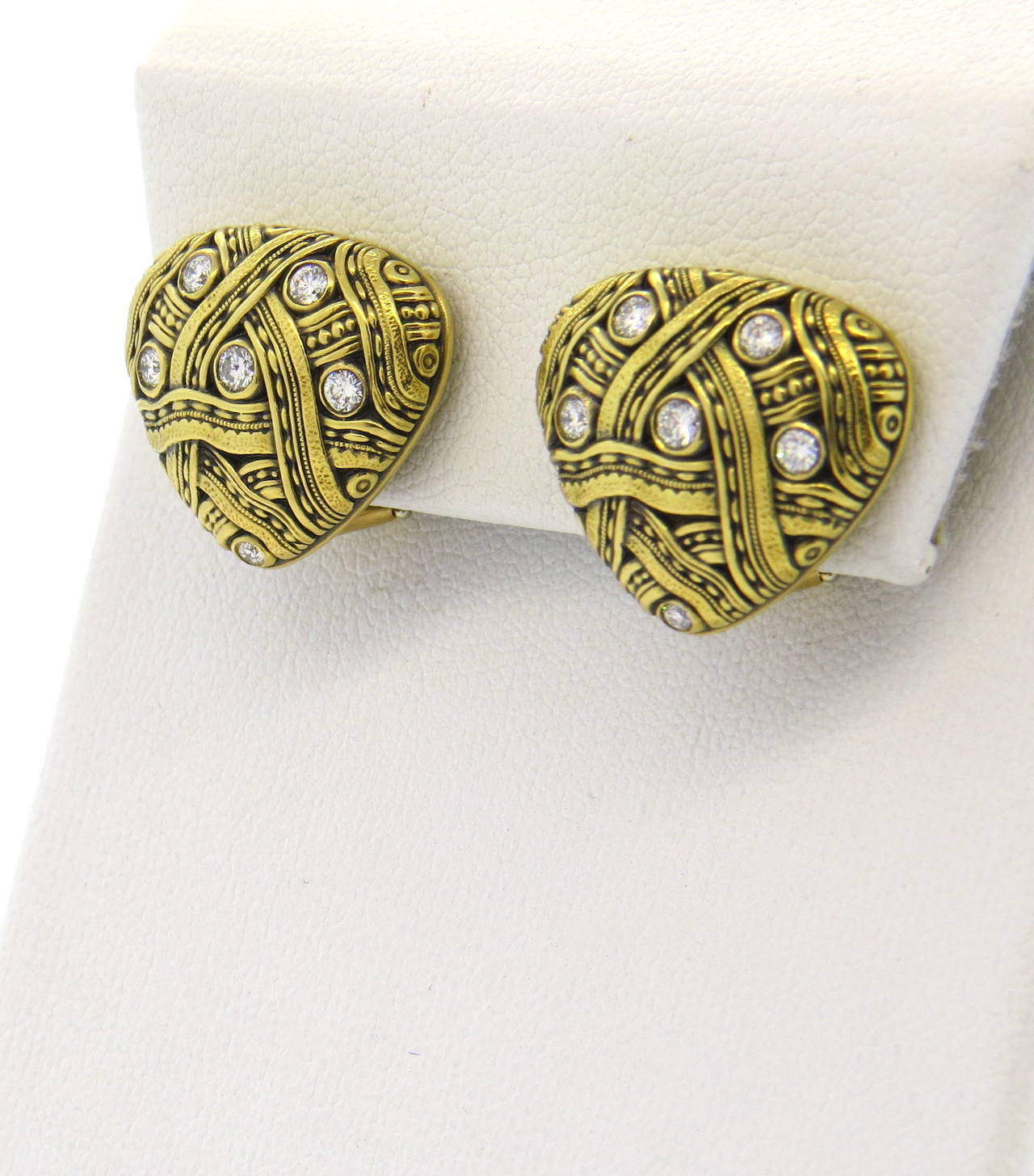 A pair of 18k yellow gold earrings set with approximately 0.30ctw of G/VS diamonds.  Crafted by Alex Sepkus, the earrings measure 19mm x 16.5mm and weigh 13.4 grams.  The earrings have clip backs.