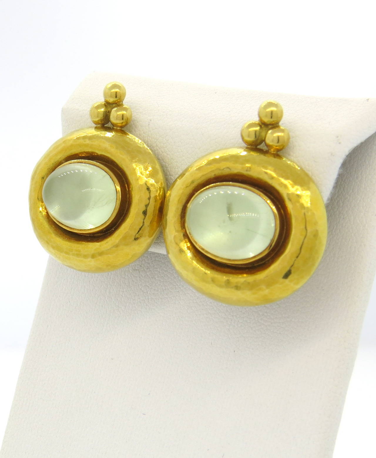 A pair of 18k yellow gold earrings set with moonstone cabochons (14mm x 10mm) backed with mother of pearl.  Crafted by Elizabeth Gage, the earrings measure 30mm x 27mm and weigh 28.9 grams