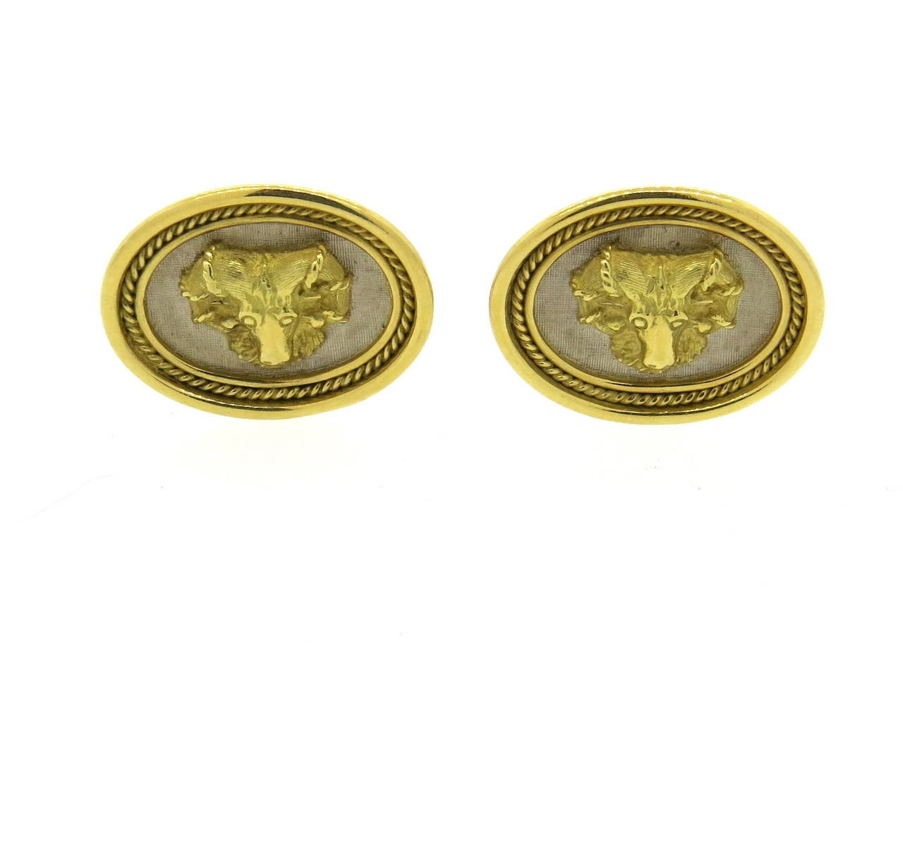 An 18k yellow and white gold pair of cufflinks featuring Ram's heads.  Crafted by famed British designer Elizabeth Gage, the cufflinks measure 24mm x 19mm and weigh 27 grams.