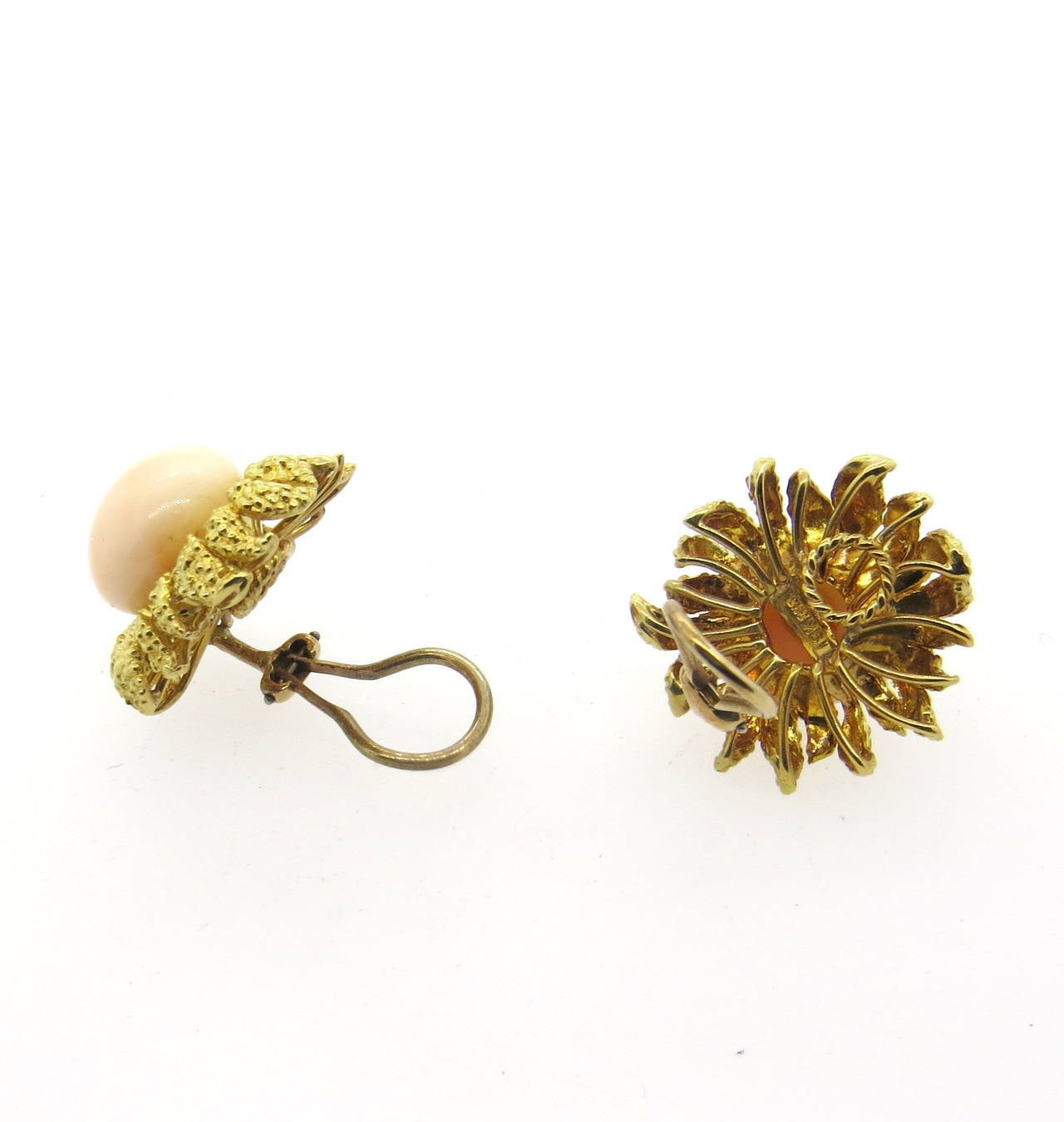 A pair of 18k yellow gold earrings set with coral (13.6mm in diameter).  The earrings measure 25mm x 24mm and weigh 23 grams.