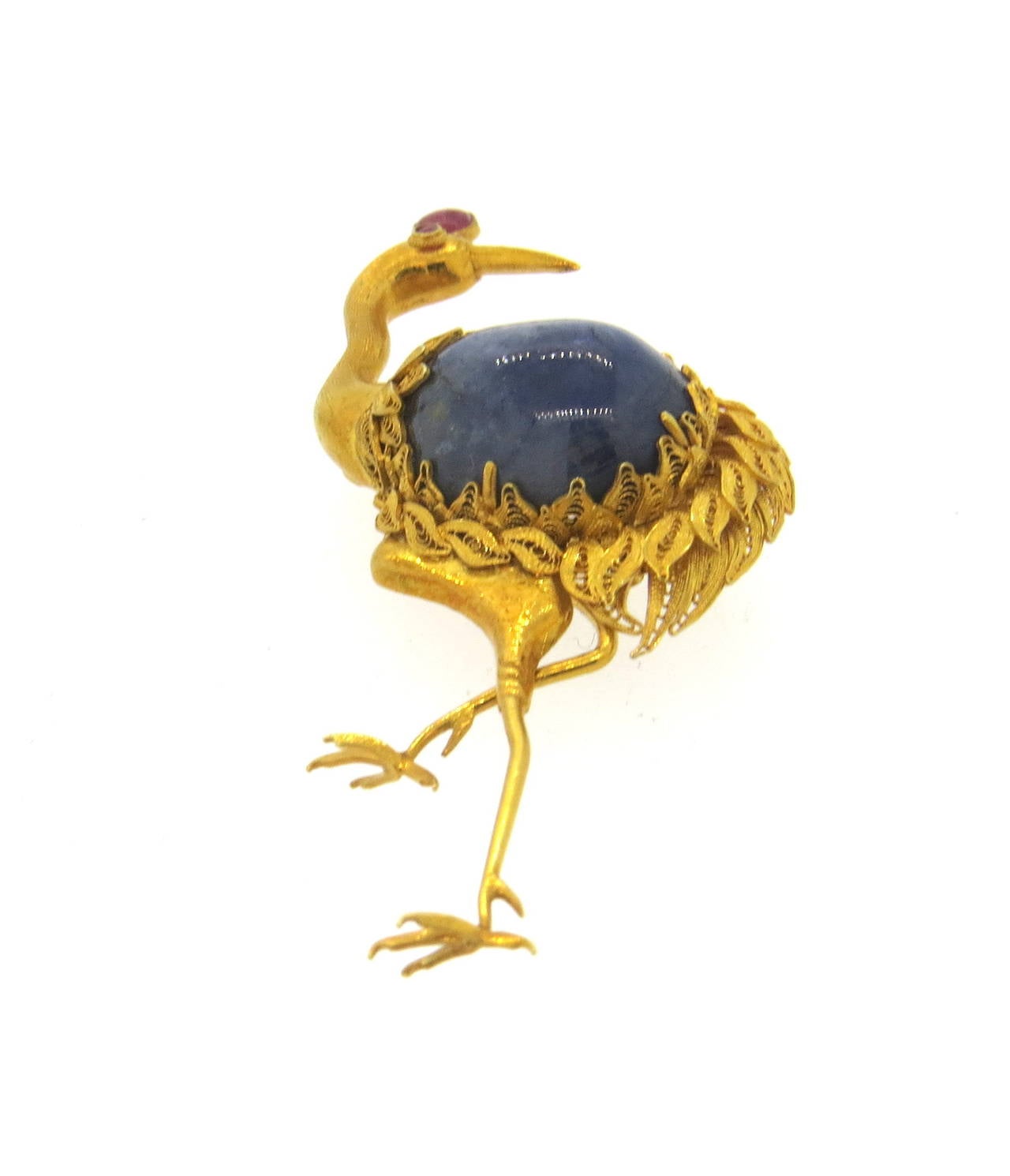 14k gold brooch pin, depicting crane, set with 19.3mm x 14mm sapphire cabochon, weighting approx. 20ct and ruby. Brooch measures 65mm x 35mm. Weight of the piece - 14.6 grams
