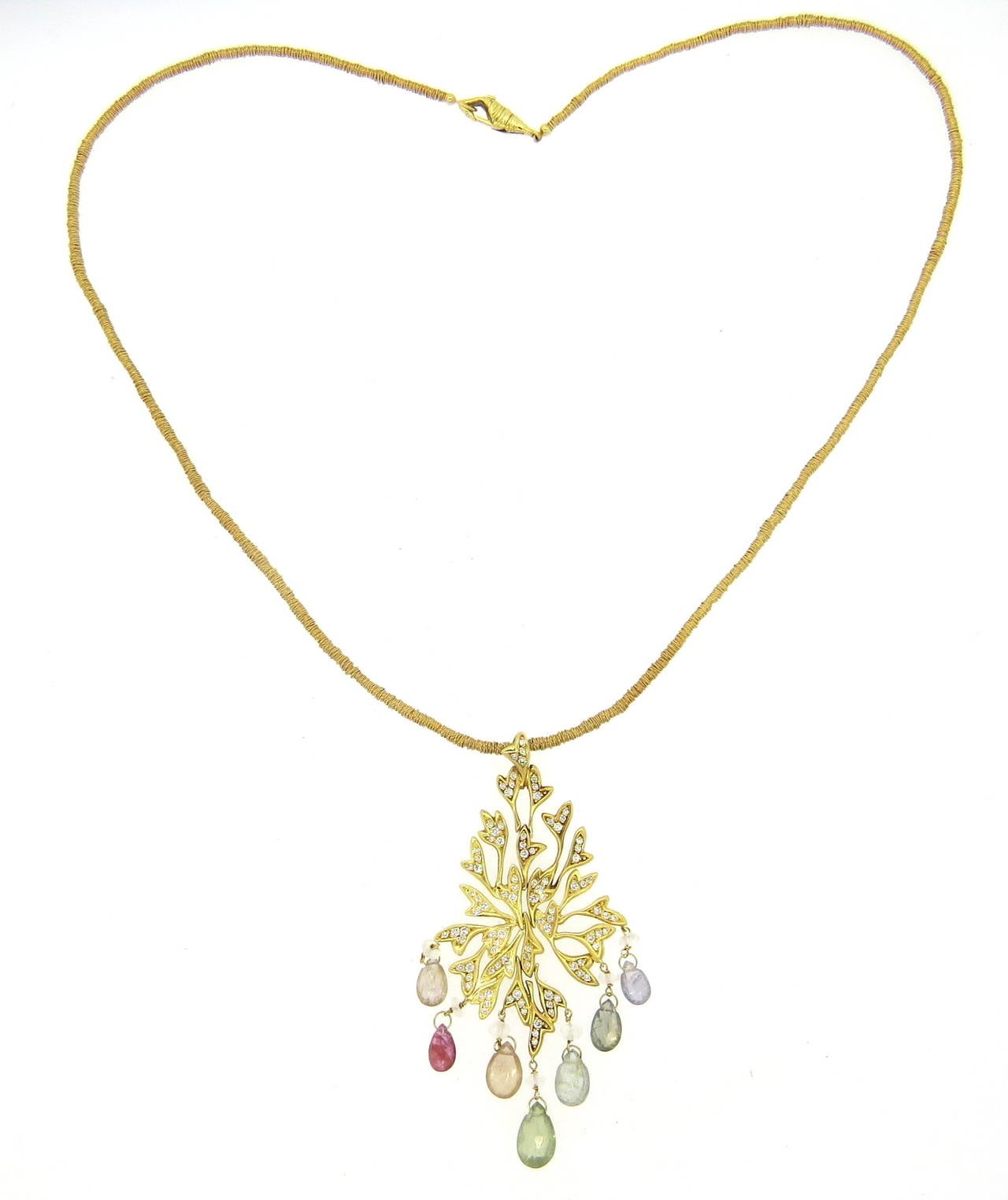 An 18k yellow gold pendant set with approximately 0.80ctw of H/VS-SI diamonds and multi color gemstone briolettes.  Crafted by H. Stern, the necklace measures 19.5