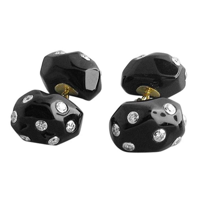 Trianon 18k gold cufflink and stud set, featuring approximately 1.20ctw in diamonds and onyx top.  Cufflink top measures 15.9mm X 11.1mm, Stud top 11.8mm X 11.7mm. Weight of the set is 23.7g.