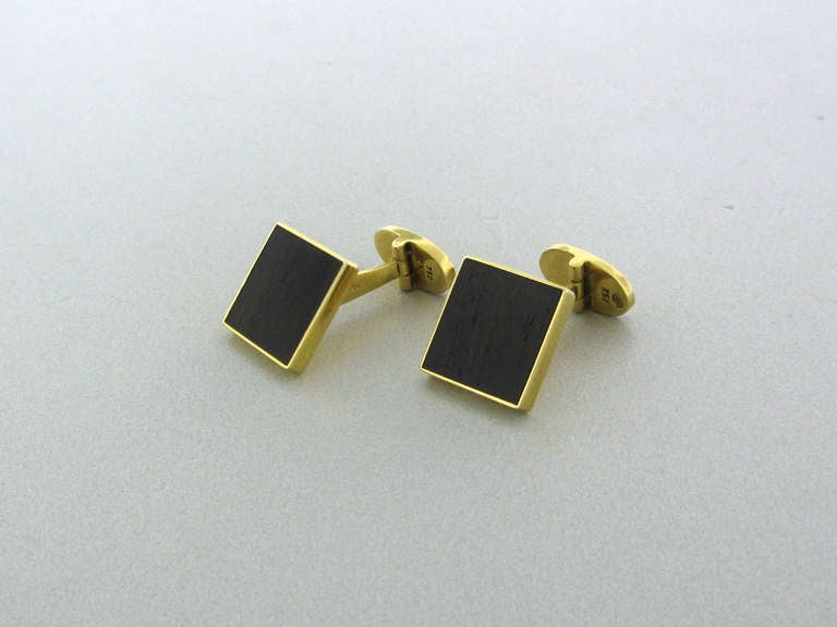 18k gold cufflinks by Gubelin with wood. Cufflink top measures 14mm x 14mm. Weight 11.2g