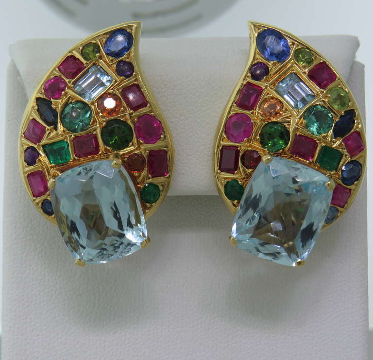 Beautiful and bright 18k gold earrings; featuring multicolor gemstones, featuring sapphire, aquamarine, emerald, ruby, peridot. Marked 18k, MFC. Earrings measure 40mm x 26mm. Weight 35.2gr.