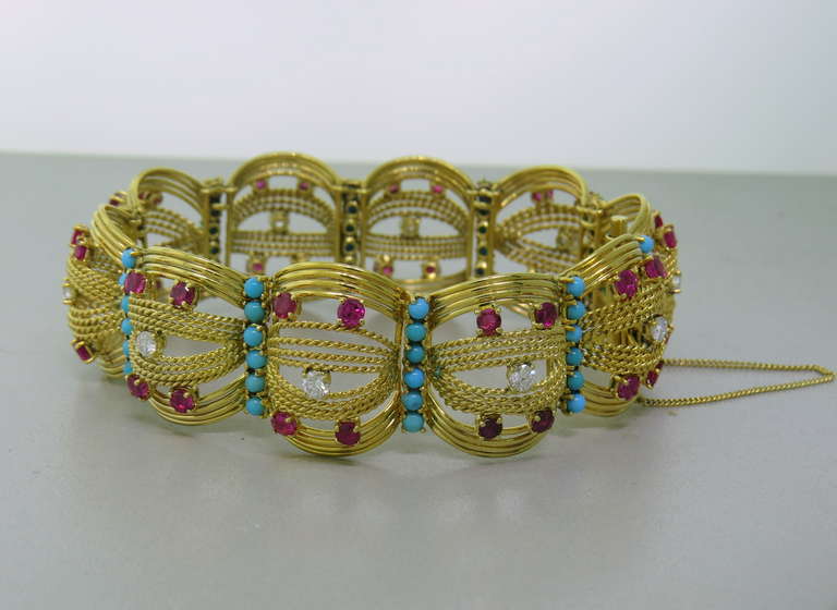 1960s 18k gold bracelet by Spritzer and Furman, featuring approximately 1.00ctw diamonds,  turquoise and rubies. Bracelet is 7 1/4