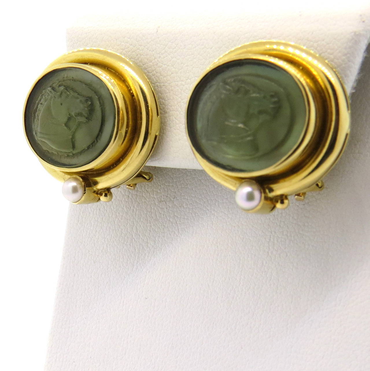 A pair of 18k yellow gold earrings with carved venetian glass depicting horses adorned with 4.4mm pearls.  Crafted by Elizabeth Locke, the earrings measure 25mm x 23mm and weigh 18.5 grams.