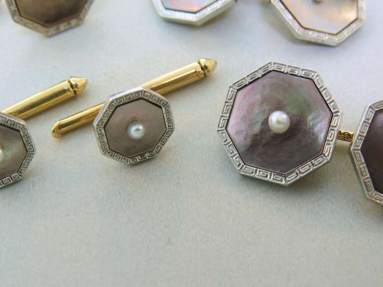 1920s Art Deco 14k gold set of cufflinks and studs, featuring mother of pearl top,with pearl in the center  and   etruscan pattern border . Cufflink top measures 14mm x 1mm, large stud measures 13mm x 13mm,small stud top is 9mm 9mm. weight of the