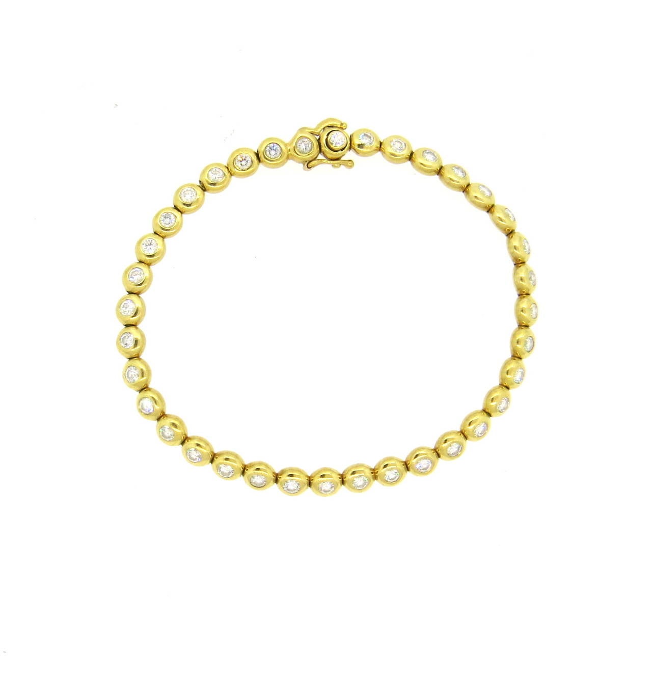 An 18k yellow gold bracelet set with approximately 2.20ctw of G/VS diamonds.  Crafted by Tiffany & Co, the bracelet is 7