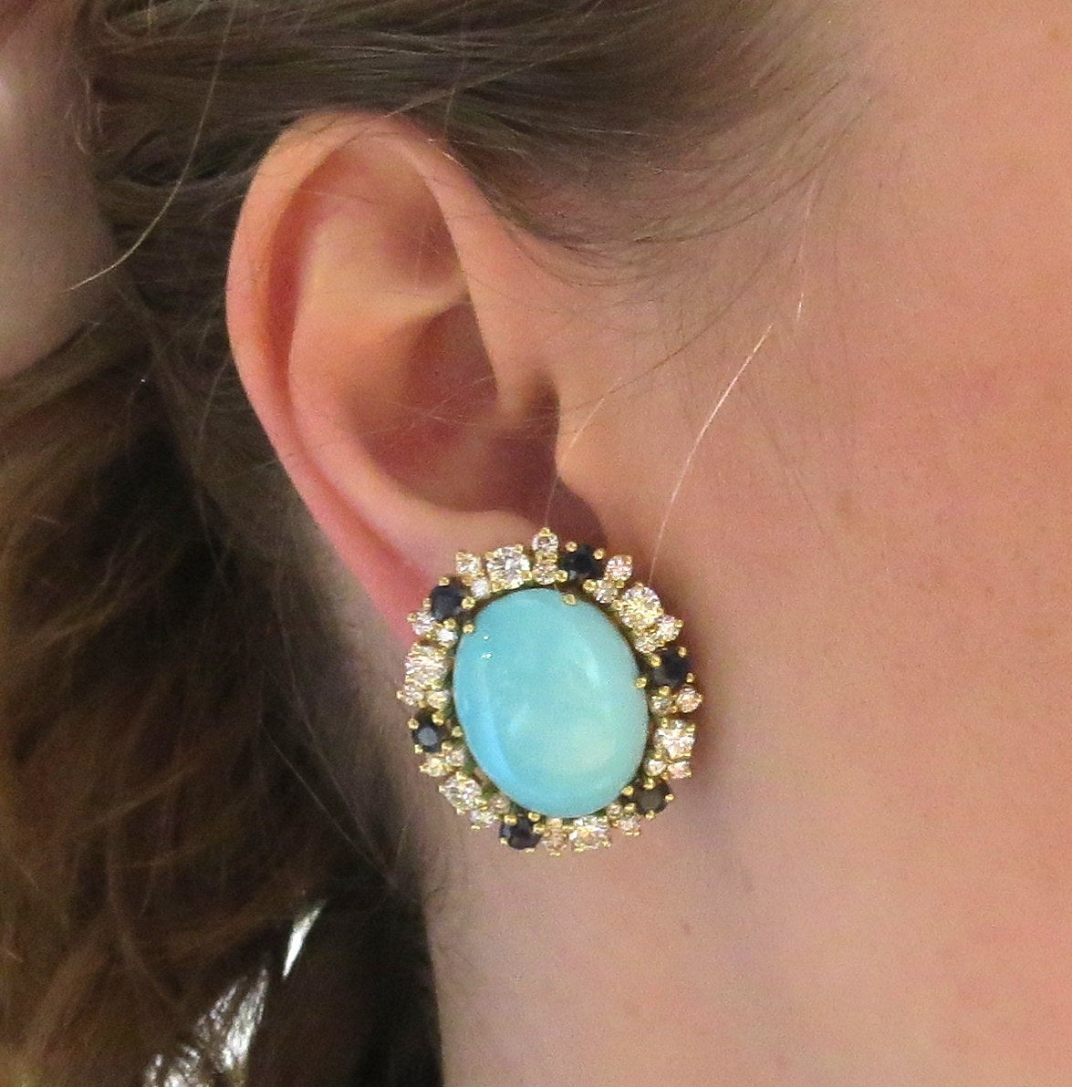 Impressive 18k gold earrings, set with two 20mm x 16mm turquoise stones, surrounded with blue sapphires and approximately 4.0-4.20ctw in diamonds. Earrings measure 29mm x 26mm. Weight - 31.5 grams