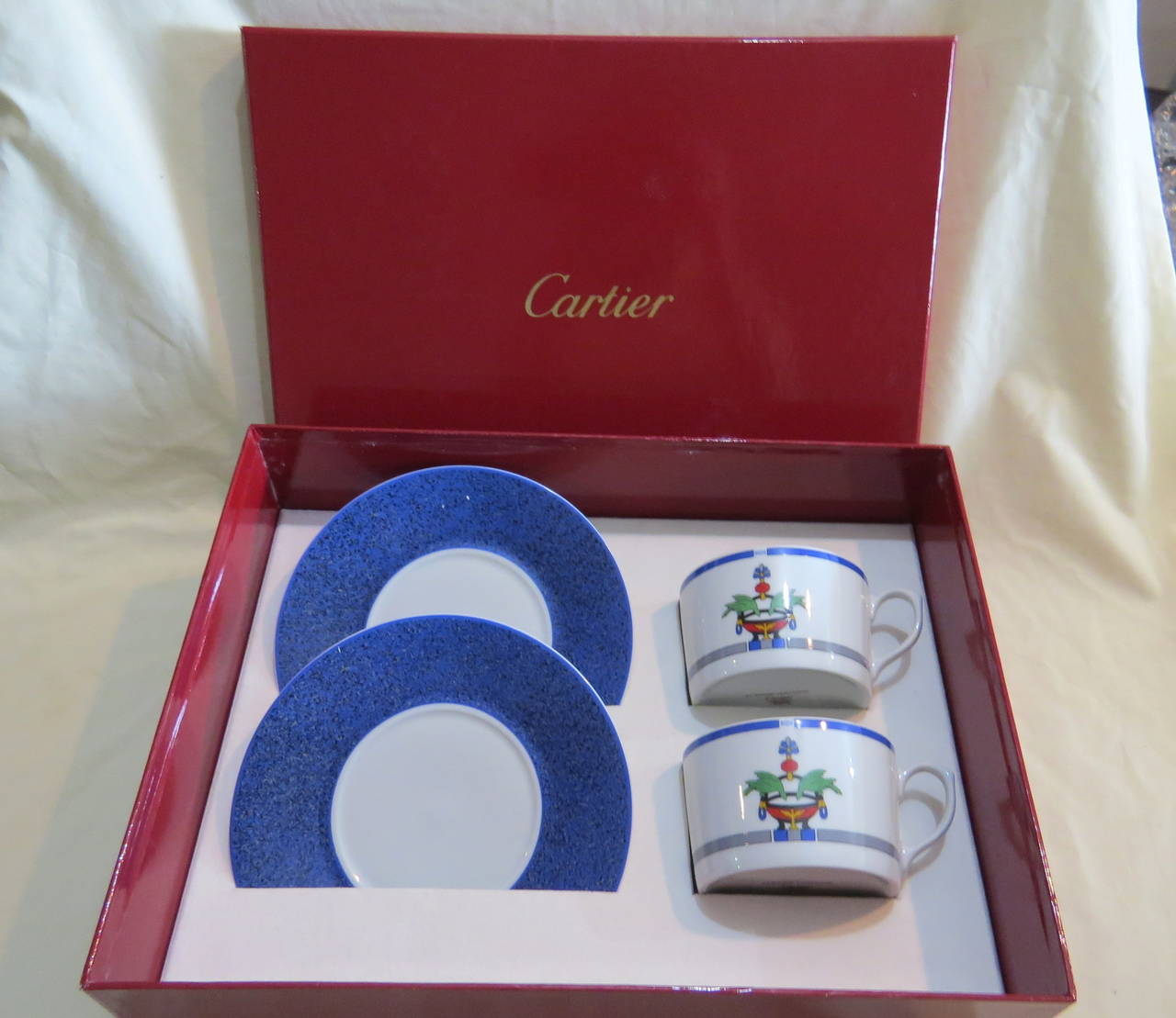 Exceptional porcelain breakfast cup with saucer set for two, crafted by Cartier for La Maison Venitienne collection in lapis color.  Set includes two cups and two saucers in original Cartier box. Diameter of the cup 3 15/16