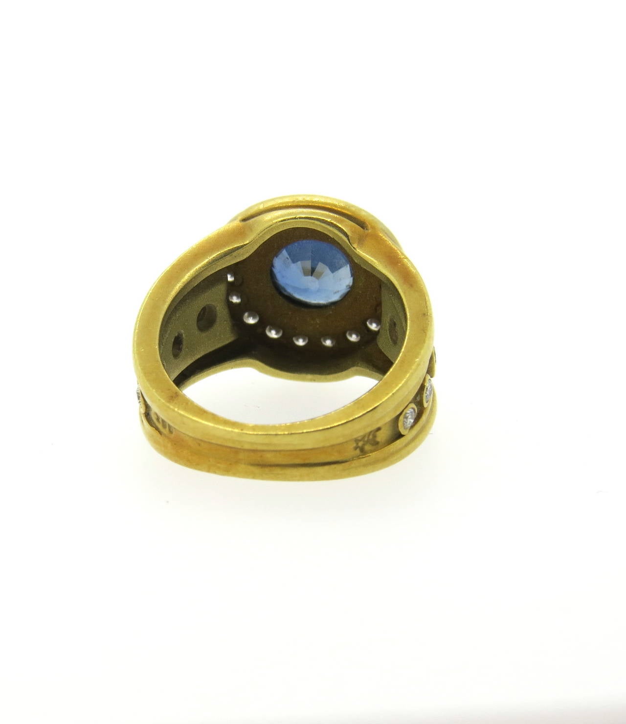 An 18k gold ring set with a sapphire weighing approximately 1.45ct accented with approximately 0.50ctw of G/VS diamonds.  Crafted by Barry Kieselstein-Cord, the ring is a size 5.25 and weighs 11.1 grams.
