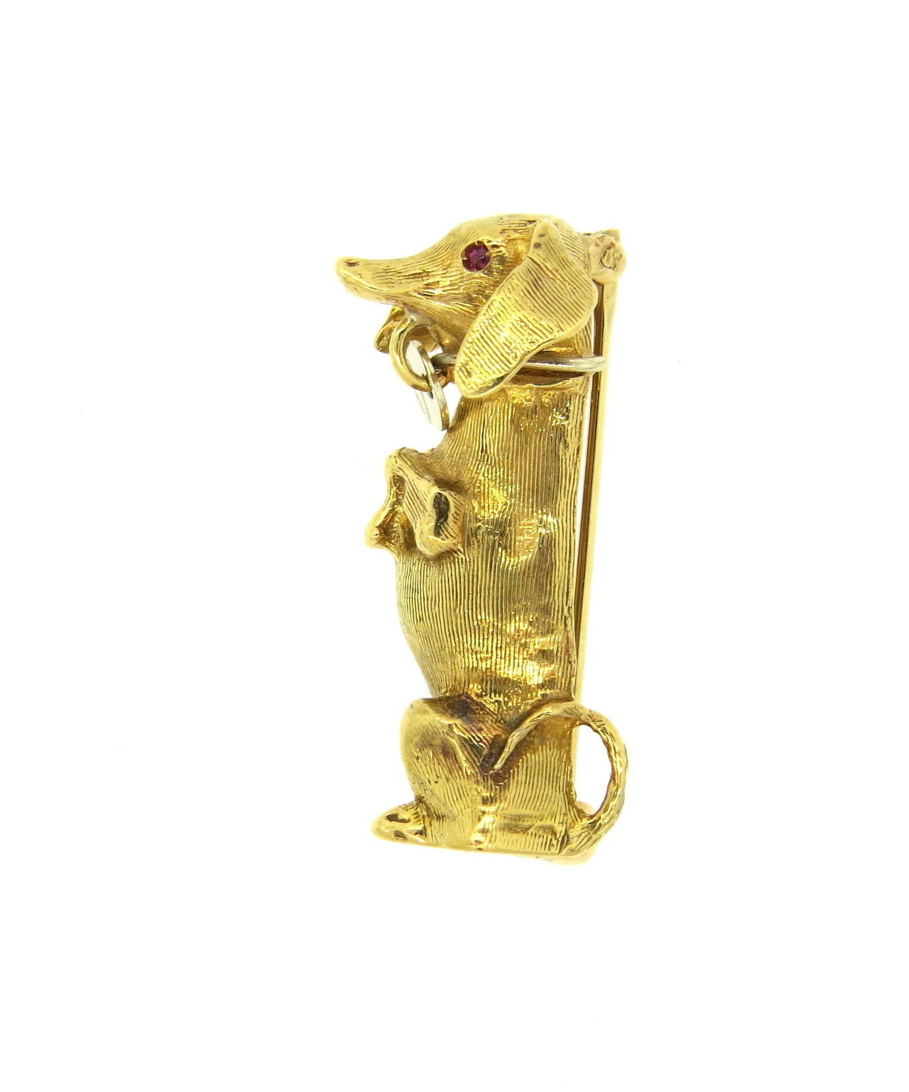 Vintage 18k gold brooch pin, depicting dachshund dog, with ruby eyes. Brooch measures 31mm x 15mm. Weight of the piece - 7.4 grams