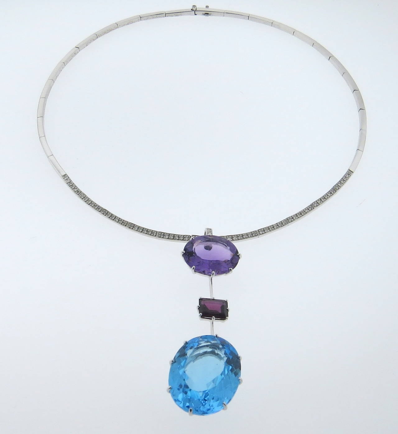 18k white gold necklace, crafted by H Stern, decorated with approximately 0.64ctw in diamonds, 18mm x 15mm amethyst, 25mm x 20mm x 21mm  blue topaz and 9mm x 7mm pink tourmaline gemstone drop pendant. Necklace is 16 1/4